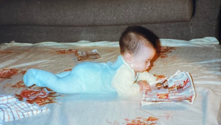 Troy as a baby, reading